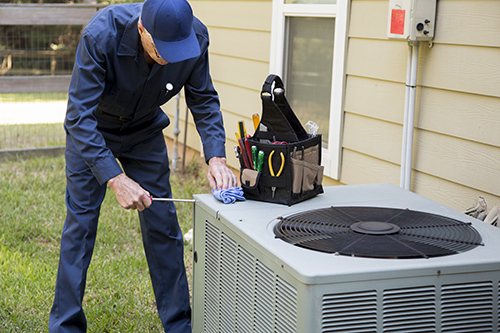 Technician services outside AC units and generator.